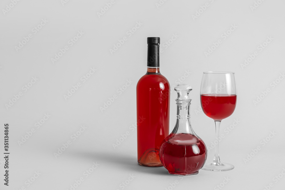 Decanter and bottle of wine with glass on grey background Decanter and bottle of wine with glass on grey background