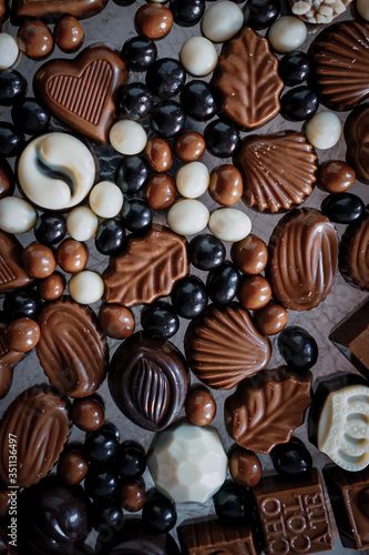 Traditional Turkish Candies designed on black surface with chocolate.Conceptual image of celebrations. Close-up chocolate. Religious Holiday, The Sugar Feast After Ramadan. Top view. 