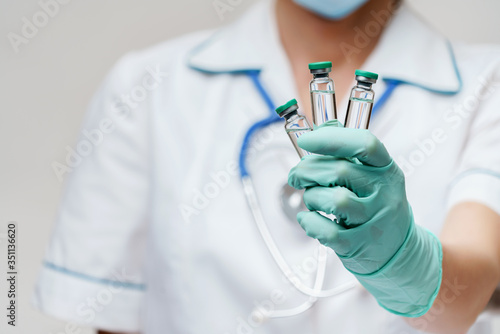 health medical worker woman holding tube with vaccine