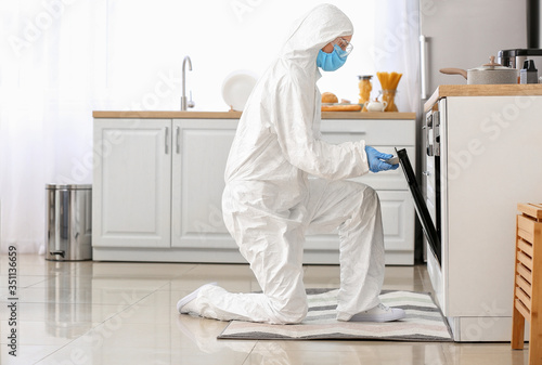 Woman in biohazard suit coo...