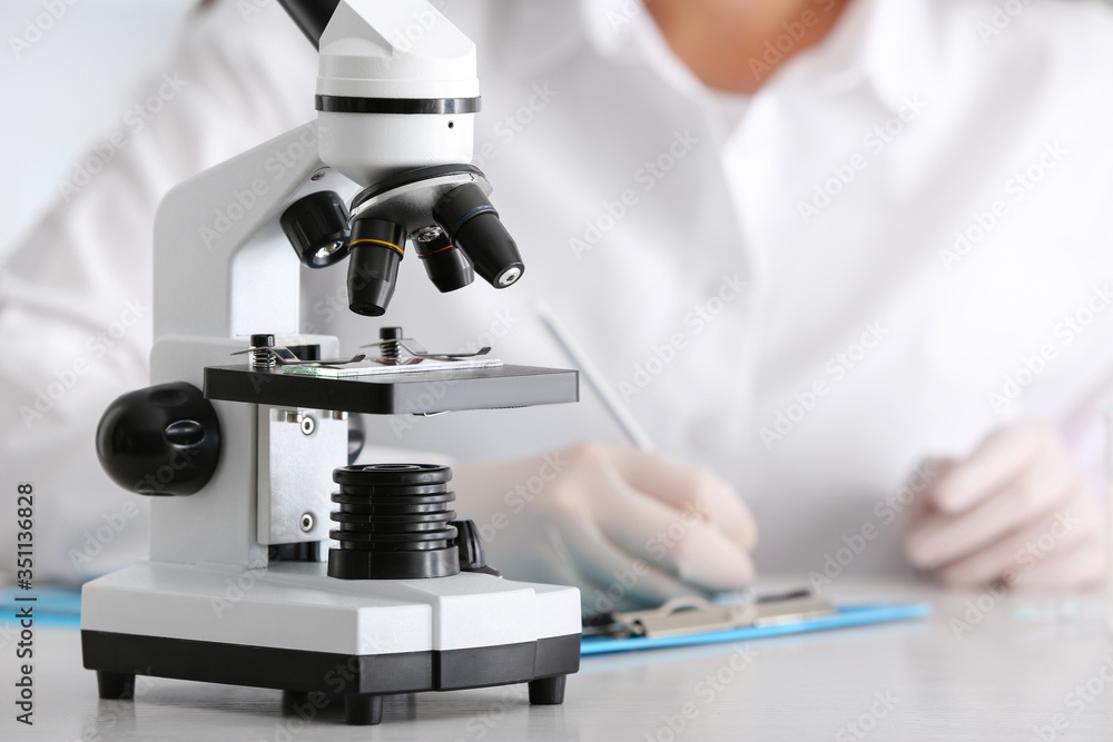 Modern microscope on table in laboratory Modern microscope on table in laboratory