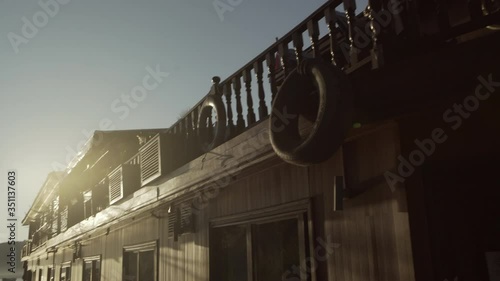 Cruise ship moored at riverbank against sky during sunset, scenic view of river and mountains - Luang Prabang, Laos