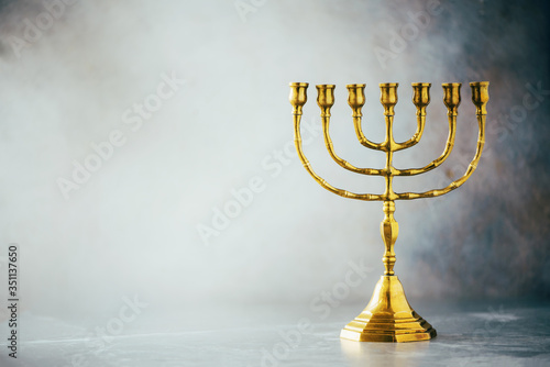 Foto Golden hanukkah menorah on grey background