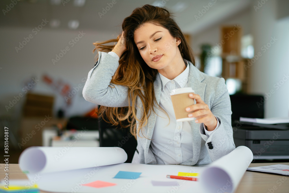 Beautiful young woman with cup of coffee. Woman enjoys fresh coffee in the morning on her desk at the office. Beautiful young woman with cup of coffee. Woman enjoys fresh coffee in the morning on her desk at the office.