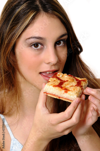 A woman eating a piece of pizza