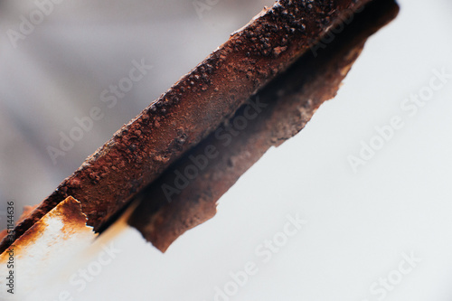 Scrap metal. Rust under a coat of paint. Peeled off white paint. Corrosion on an old satellite dish. Close-up. Macro. Corrosion of metal