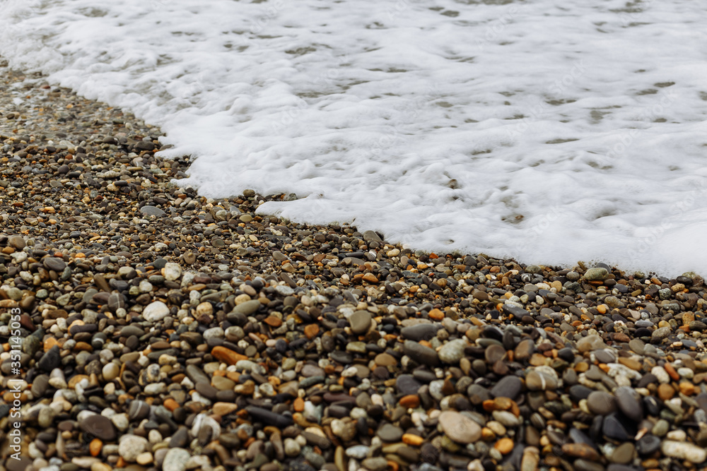 Shore of the Black Sea. In the foreground are photographs of a pebble beach and sea stretching over the horizon. Waves at sea. Shore of the Black Sea. In the foreground are photographs of a pebble beach and sea stretching over the horizon. Waves at sea.