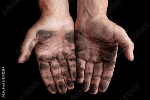 dirty male hands on a black background