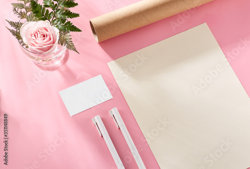 Corporate identity with pastel concept. Stationery branding, card, letterhead, book mock-up on light pink background, with paper, pens, camera, rose elements. Blank objects for placing your design (ID: 351148849)