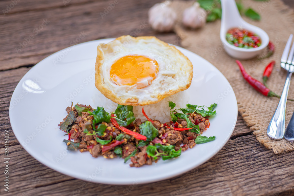 Thai Food Rice topped with egg and stir-fried beef and basil, famous street food in Thailand, fast food, soft focus
