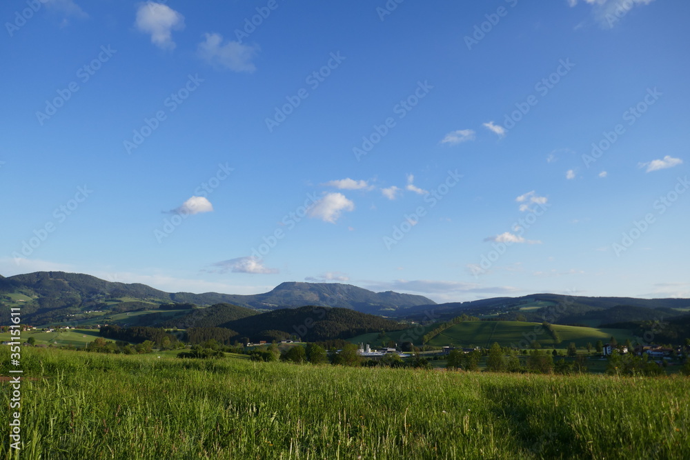 Field and mountains, beautiful landscape in Austria in a village.