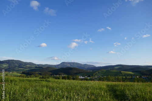 Field and mountains, beautiful landscape in Austria in a village.