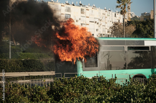 Bus under the fire on the highway photo