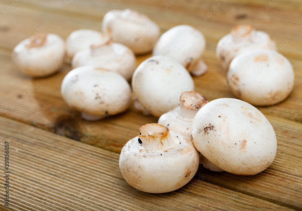 White champignon mushrooms on a kitchen table