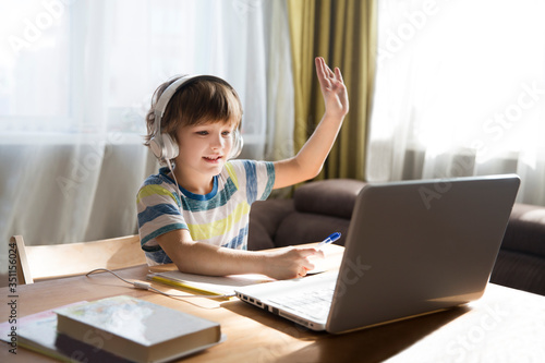 child boy is using a laptop and study online at home. homeschooling, distant learning