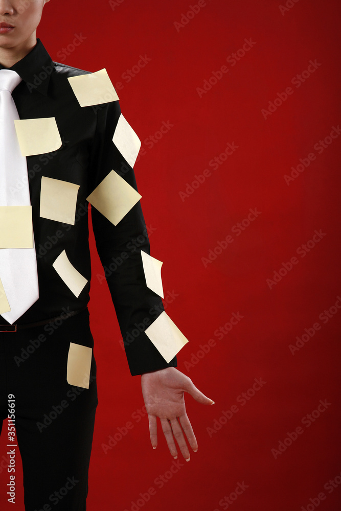 Businesswoman with adhesive notes on her suit