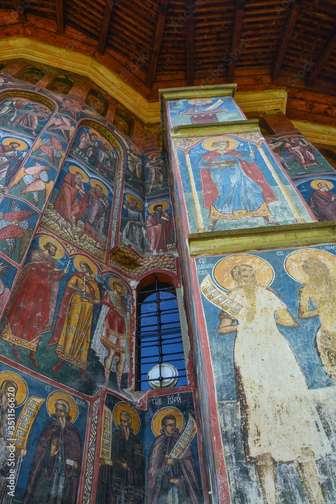 MOLDOVITA MONASTERY, BUCOVINA, ROMANIA, EUROPE, SPRING 2018. Facade of the Moldovan Orthodox Monastery with a Moldovan architectural style and outdoor paintings of portraits of saints or prophets