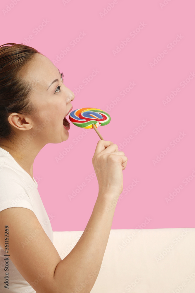 Woman about to bite on a lollipop Woman about to bite on a lollipop