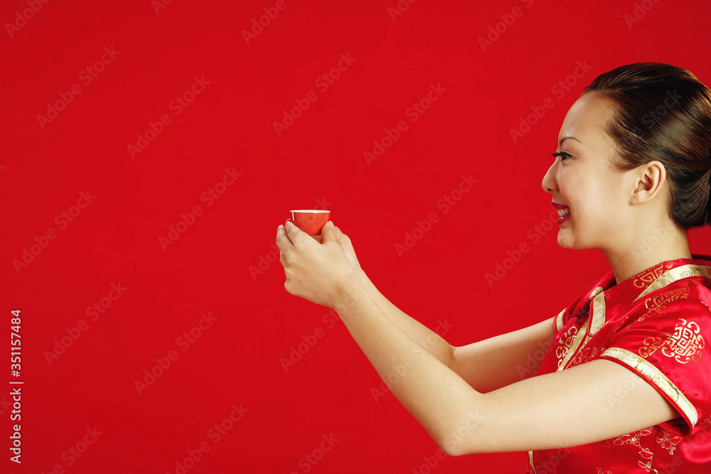 Woman holding a cup of Chinese tea