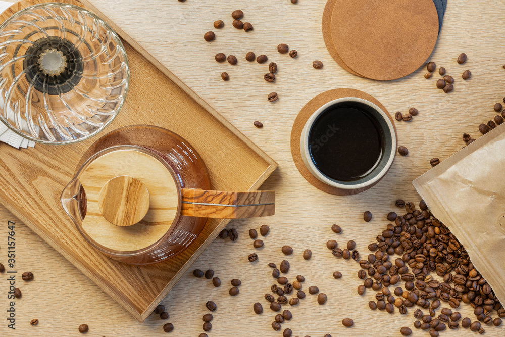 Directly above shot of fresh coffee with roasted beans on wooden table Directly above shot of fresh coffee with roasted beans on wooden table