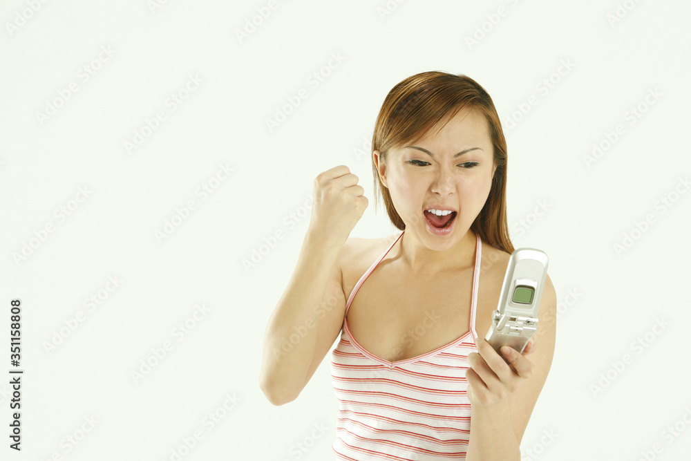 Woman cheering while looking at mobile phone Woman cheering while looking at mobile phone