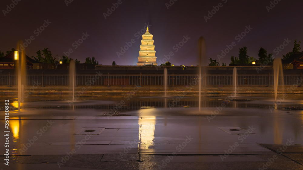 Giant Wild Goose Pagoda and water fountains in North Square, Xi'an, China at night