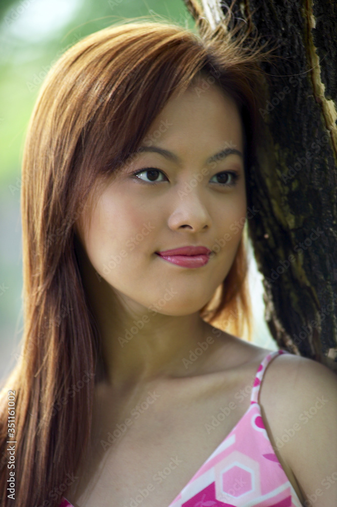 Woman smiling while staring blankly at a space Woman smiling while staring blankly at a space
