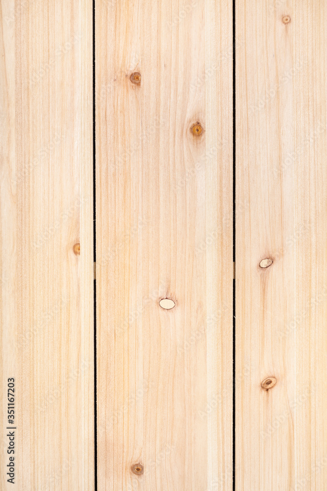 vertical wooden background - unpainted wood panel from three vertical pine planks vertical wooden background - unpainted wood panel from three vertical pine planks