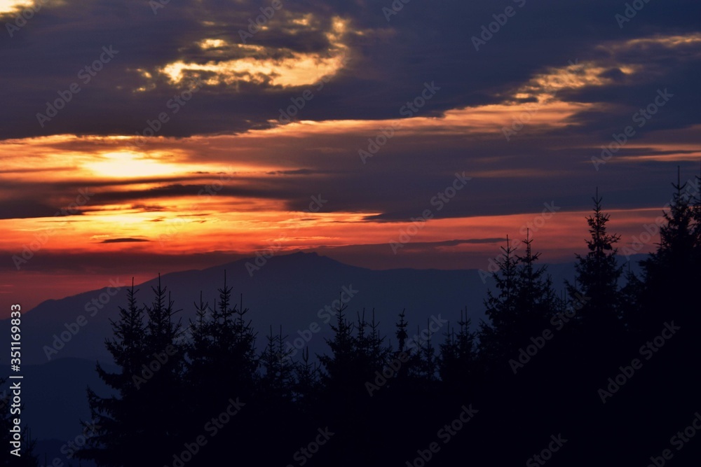 beautiful sunset with colorfully clouds at the mountain. horizon seen from high altitude