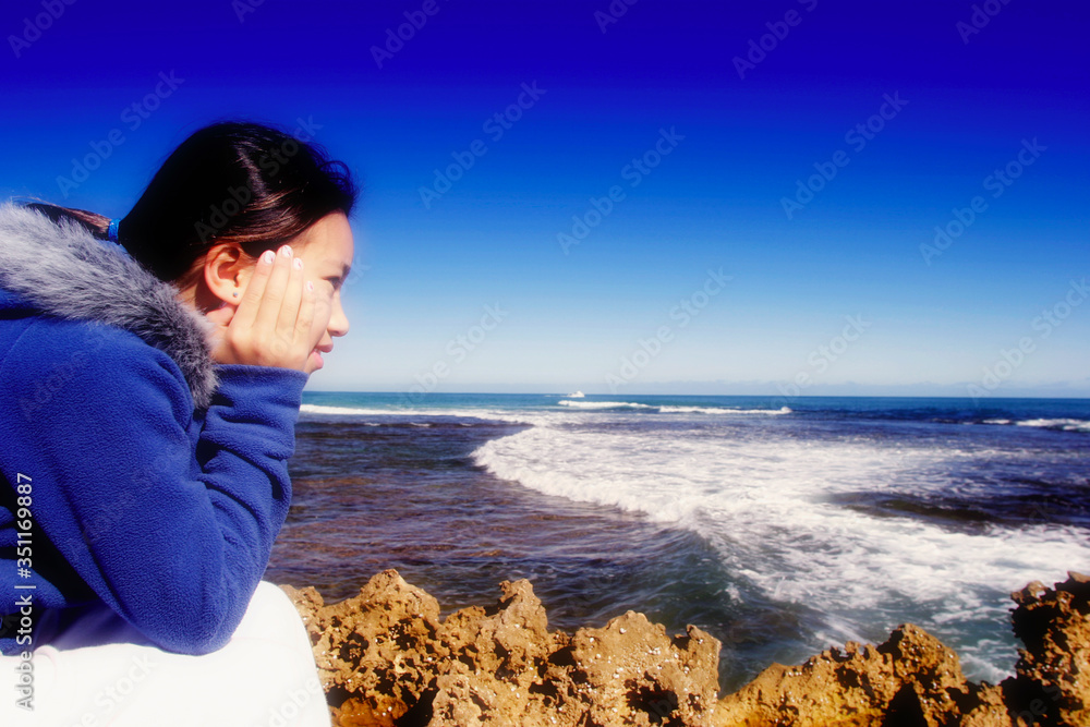 Side shot of young girl admiring the sea view