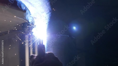 Industrial Worker, welder takes off and puts on a mask, smoking a metal pipe, Slow motion Footage