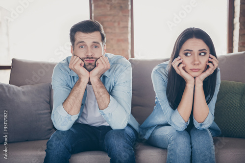 Εκτύπωση καμβά Portrait of stressed frustrated couple man woman sit divan have nothing to do on
