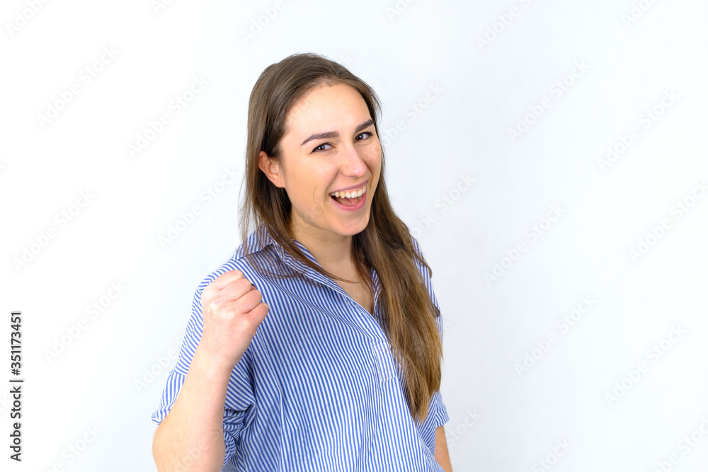Confident young woman smilling and cheering towards camera Confident young woman smilling and cheering towards camera