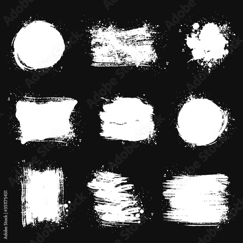 Paint brush stains. Vector grunge shapes isolated on black backgrounds.