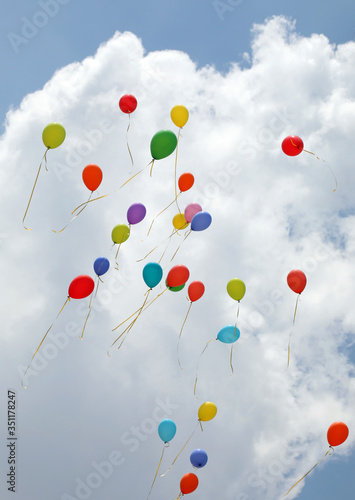 balloons inflated with helium flying high in the sky during the