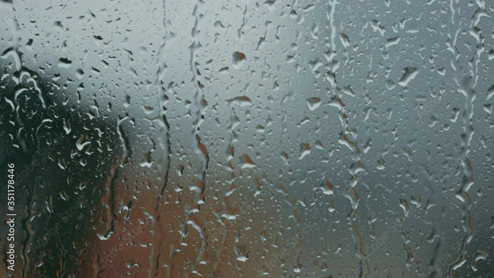 Raindrops on glass in closeup Raindrops on glass in closeup