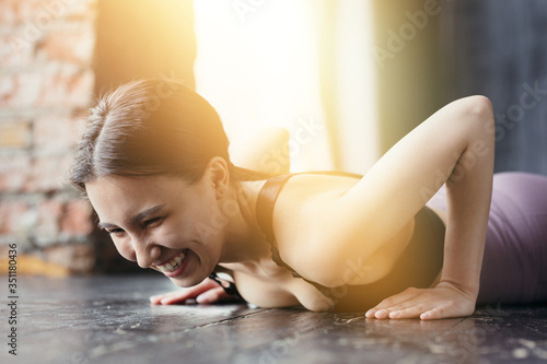Fitness trainer does push-ups in the sun. Smiling, lying down