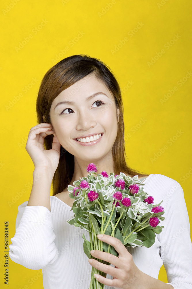 Woman holding a bouquet of flowers.