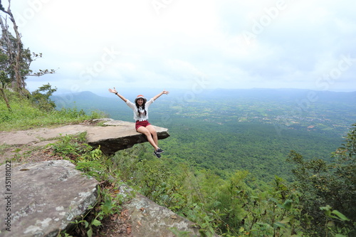Woman sitting at the edge of a cliff Sai Thong National Park in Chaiyaphum, Thailand.