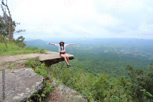Woman sitting at the edge of a cliff Sai Thong National Park in Chaiyaphum, Thailand.