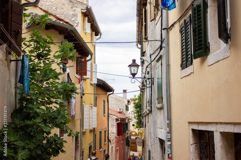 Typical narrow alley with croatian houses in the picturesque old town of Rovinj, Croatia