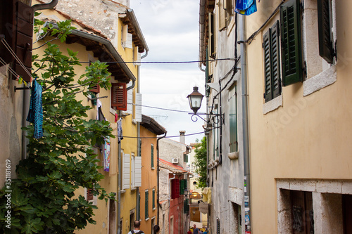Typical narrow alley with croatian houses in the picturesque old town of Rovinj, Croatia © Jesus Barroso