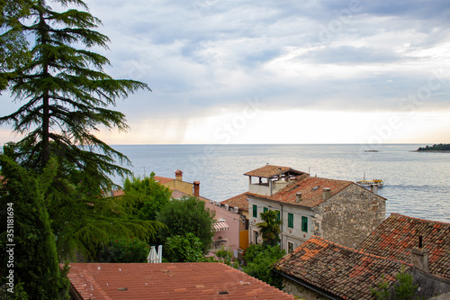 View of the horizon over the Adriatic Sea with the tiled roof of the traditional croatian houses in the old town of Rovinj, Croatia © Jesus Barroso