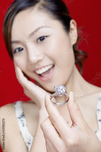 Woman showing off her diamond ring.