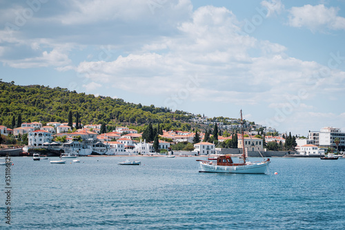 Spetses Island coast in Greece. A famous tourist destination on the Aegean sea. Old town and harbour view.