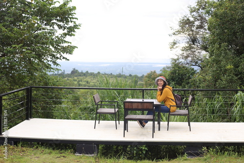 A woman sitting in a chair at the Mor Hin Khao National Park in Chaiyaphum, Thailand