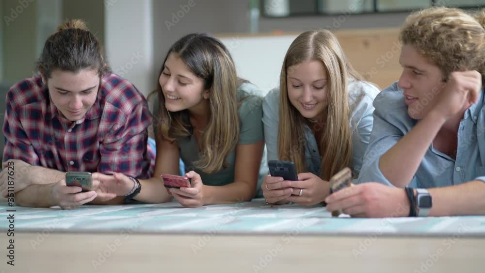 group of four young people with their phone group of four young people with their phone