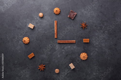 Coffee time. Various sweets and spice on stone background. Top view. Copy space