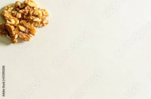 Group of peeled walnuts on the top left on white background. Healthy Food For The Heart.