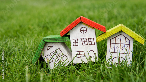 Small houses with color roofs over green and red fence